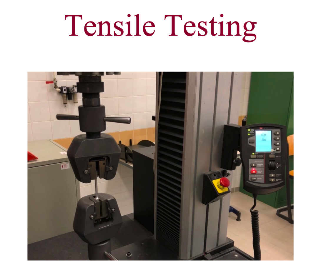 Photo of the tensile testing machine, grips, and dogbone specimen from the lab handout